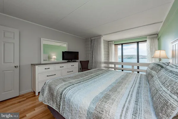 a bedroom with a bed and a dresser