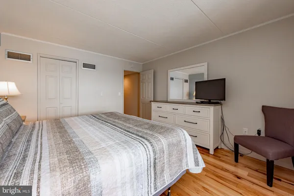 a bedroom with a bed chair and a window