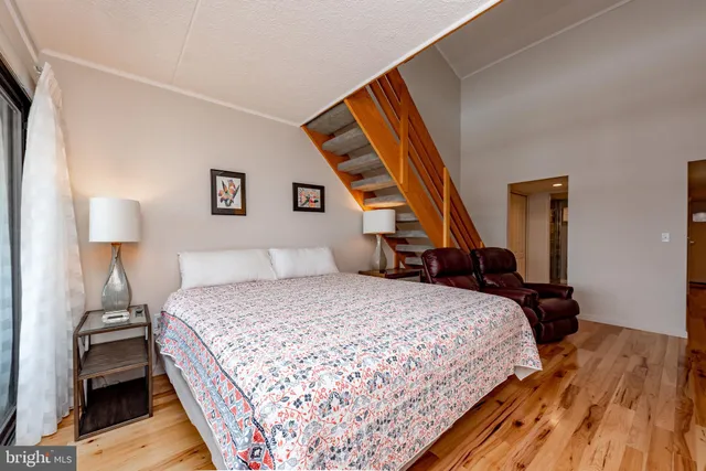 a dining room with furniture a fireplace and wooden floor