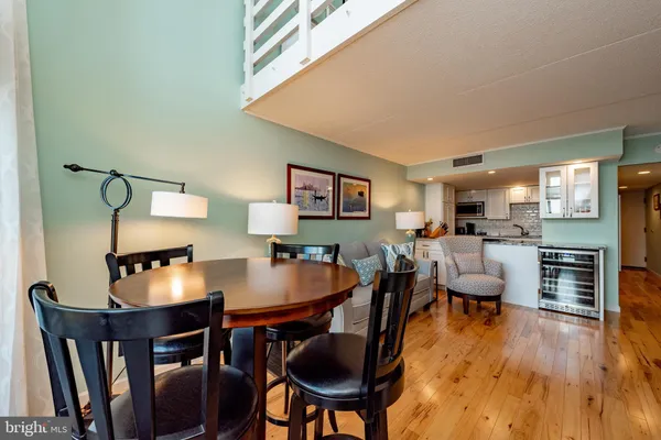 a kitchen with stainless steel appliances granite countertop a sink dishwasher stove and refrigerator with wooden floor