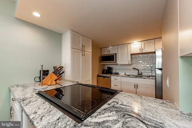 a kitchen with stainless steel appliances a stove and a refrigerator
