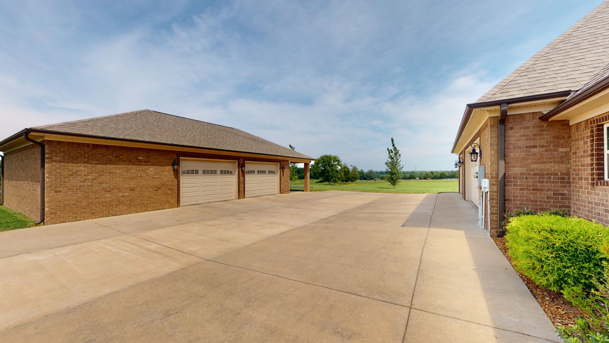 106 Rhodes Road Big Sandy, TN 38221 - Photo 48 of 49 a front view of a house with a yard and garage