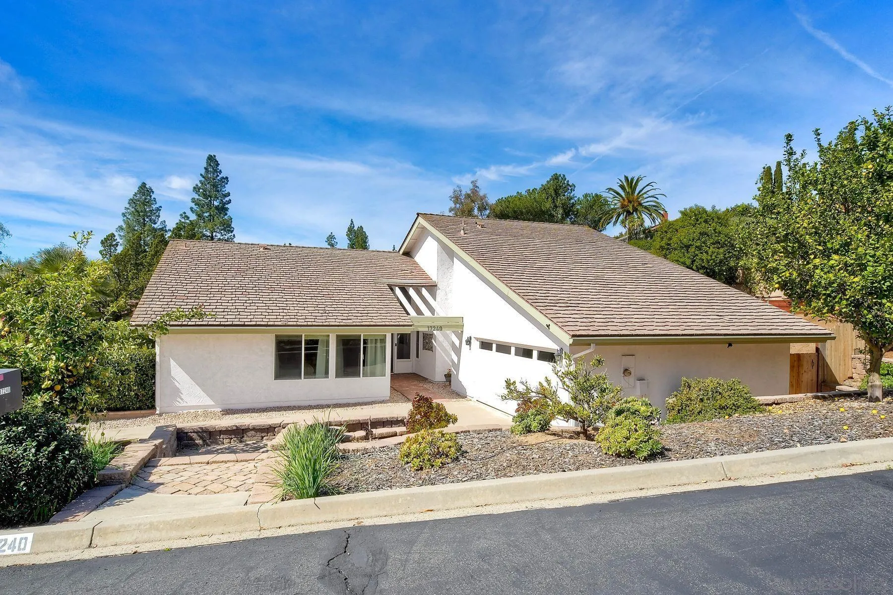 a aerial view of a house with a yard and potted plants