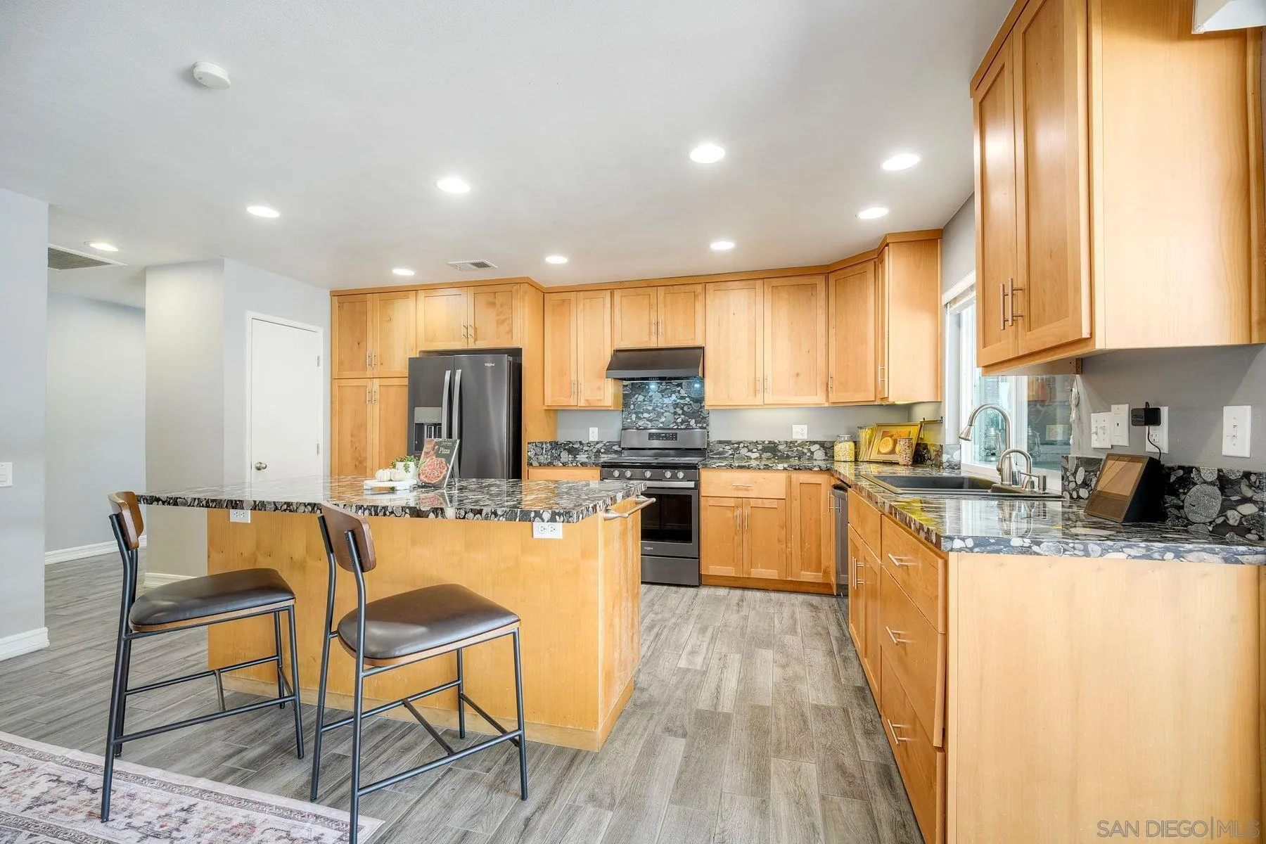 17240 Cuvee Court Poway, CA 92064 - Photo 22 of 62 a kitchen with stainless steel appliances granite countertop wooden cabinets a stove top oven a sink and dishwasher