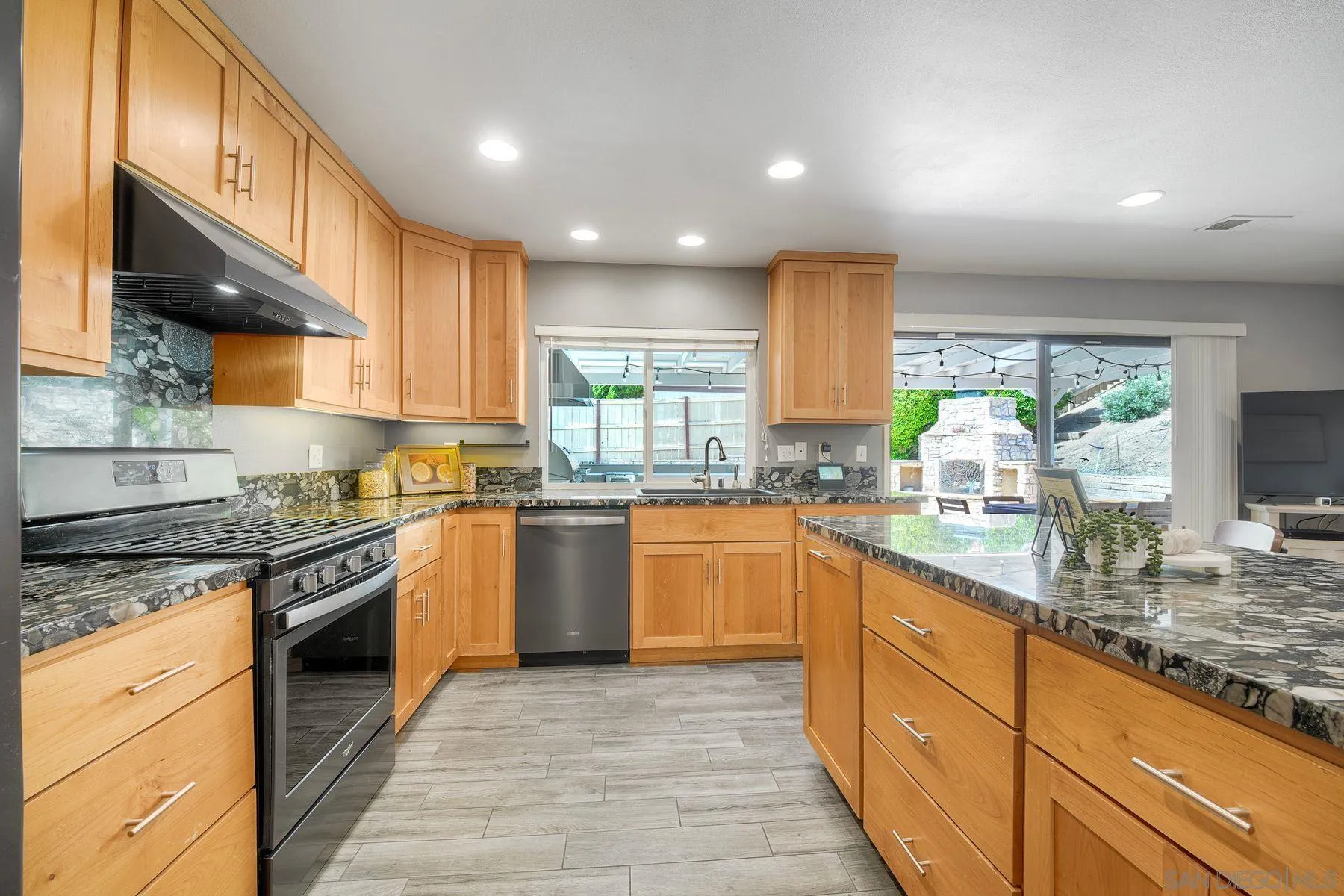 17240 Cuvee Court Poway, CA 92064 - Photo 24 of 62 a kitchen with stainless steel appliances granite countertop wooden cabinets granite counter tops and a hard wood floors