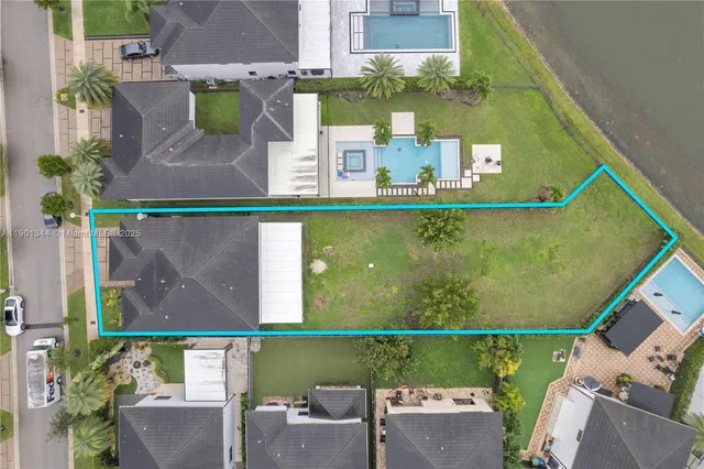 an aerial view of a house with a yard