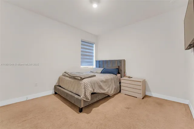 a bedroom with a bed and window