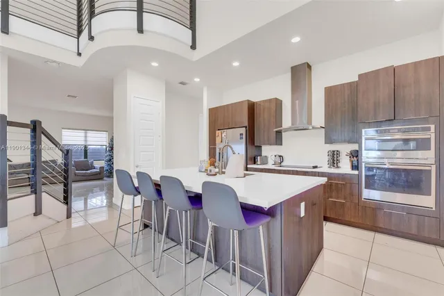 a living room with table chairs and a dining table