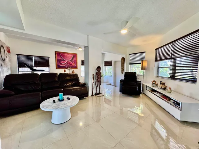 a bathroom with a granite countertop toilet sink and mirror