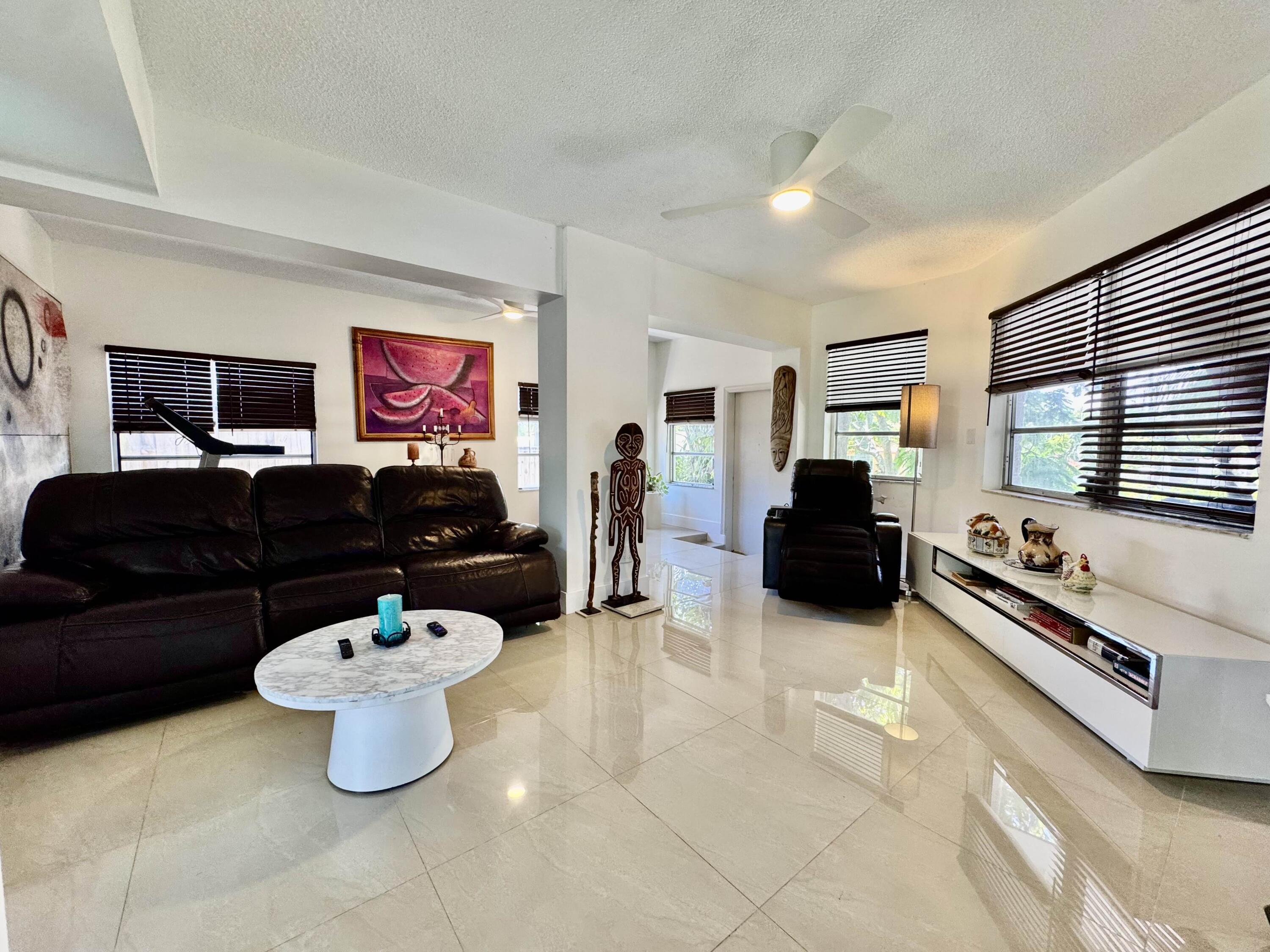 2802 Southwest 4th Street Boynton Beach, FL 33435 - Photo 14 of 42 a living room with furniture and a flat screen tv