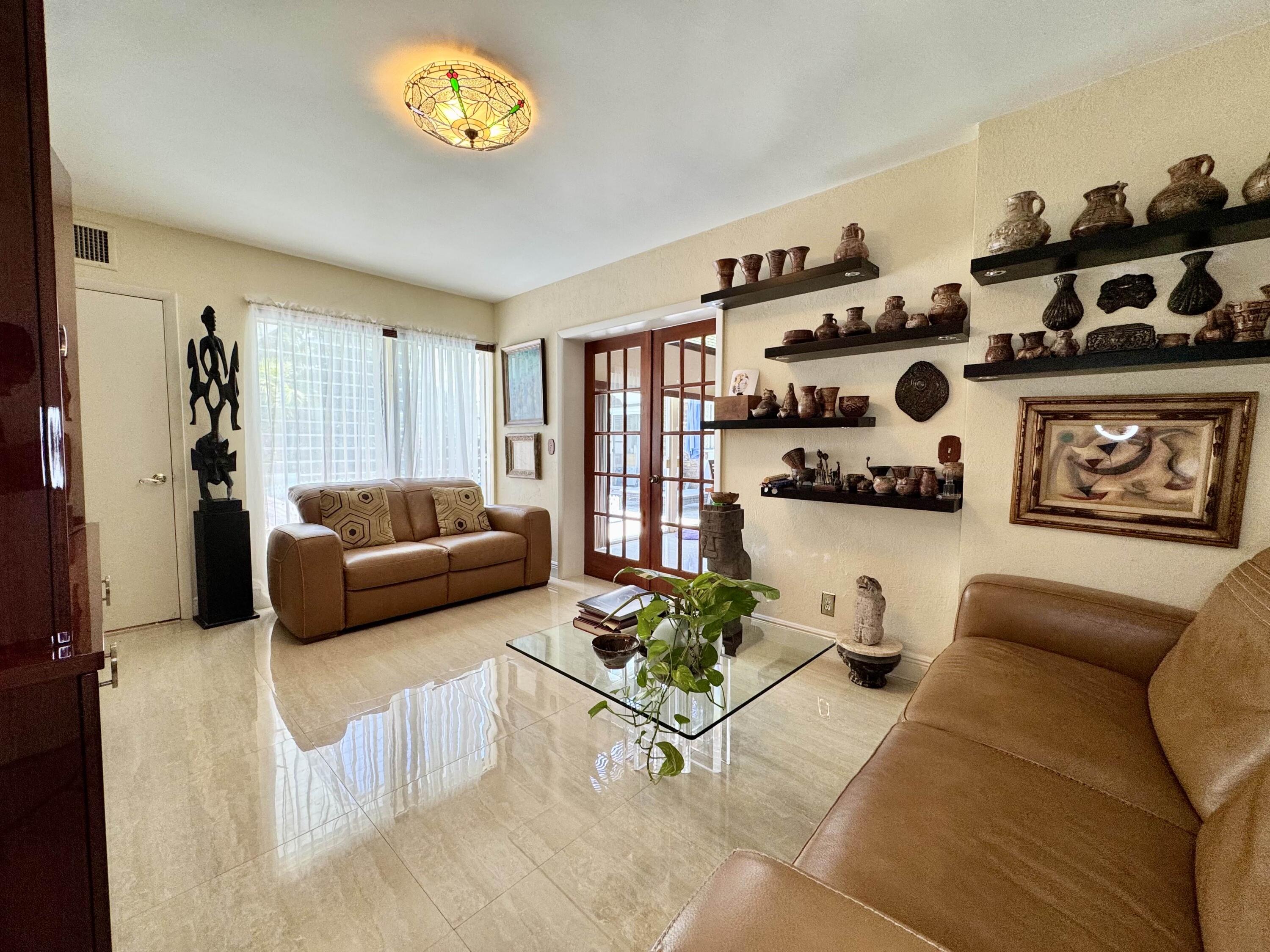2802 Southwest 4th Street Boynton Beach, FL 33435 - Photo 16 of 42 a living room with furniture and a wall painting
