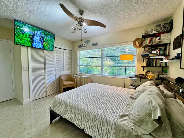 a bedroom with bed and window