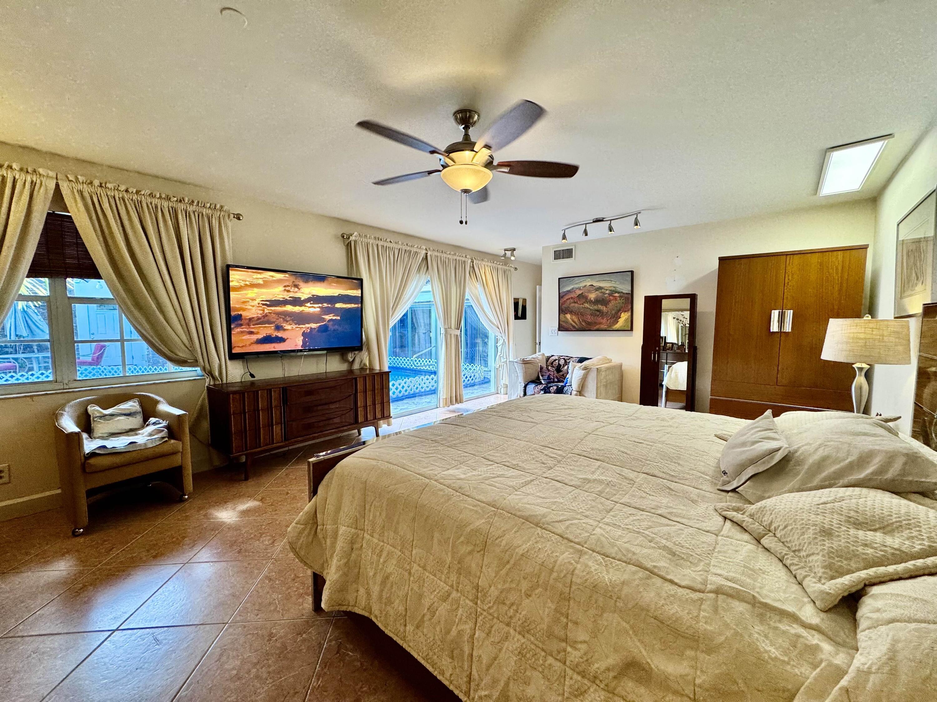 2802 Southwest 4th Street Boynton Beach, FL 33435 - Photo 26 of 42 a bedroom with a bed and a mirror