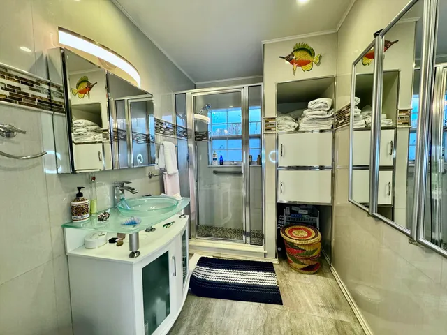 a bathroom with a sink a toilet and shower