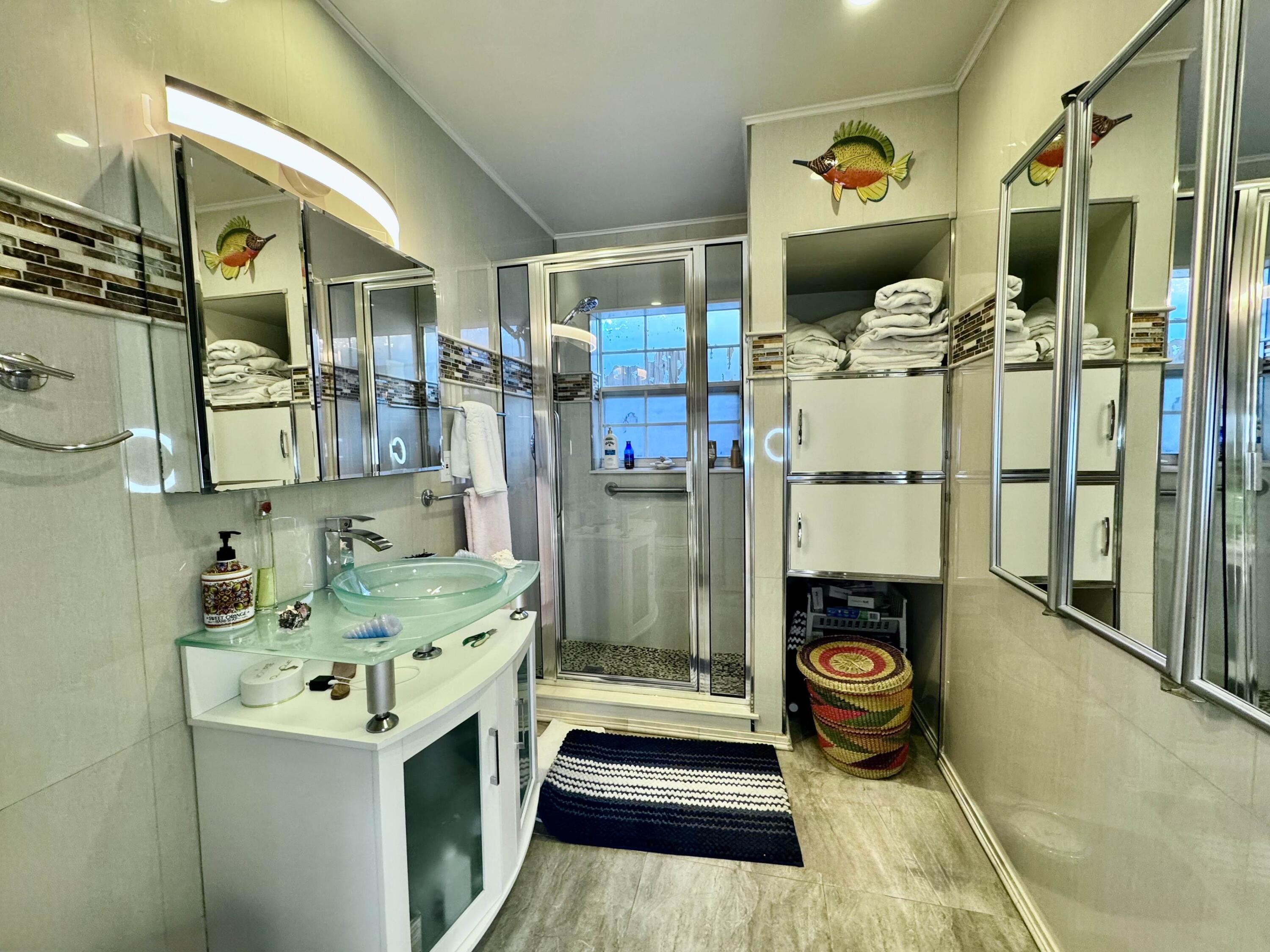2802 Southwest 4th Street Boynton Beach, FL 33435 - Photo 30 of 42 a bathroom with a granite countertop sink a toilet and shower