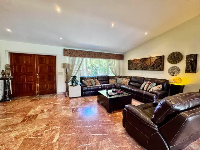 a living room with furniture window and lamp