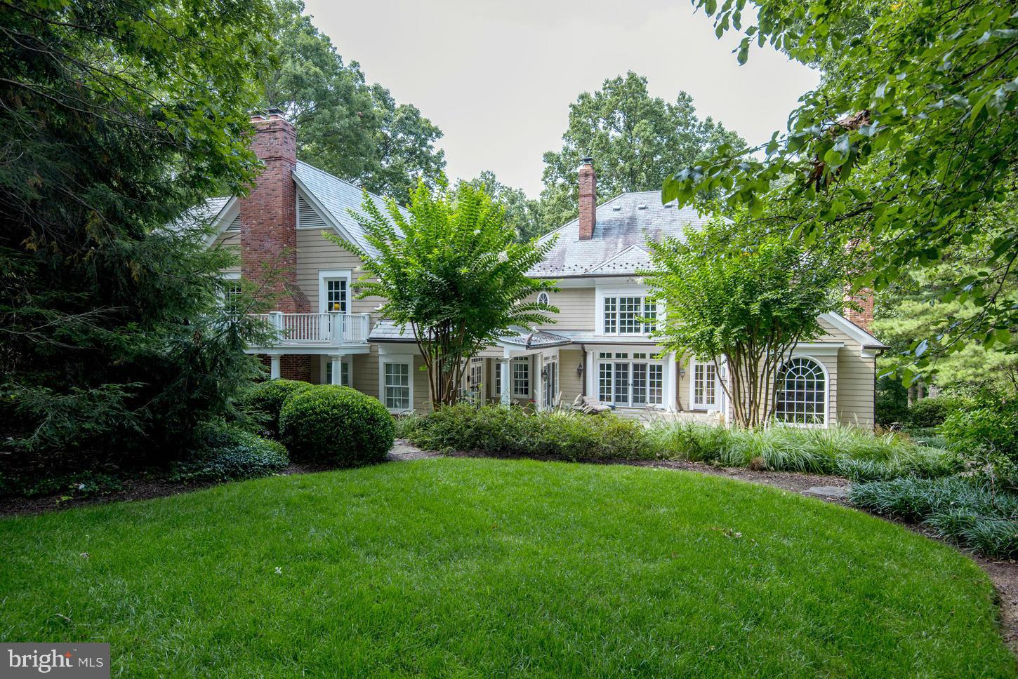 7414 Dulany Drive McLean, VA 22101 - Photo 12 of 30 a front view of a house with a yard and potted plants