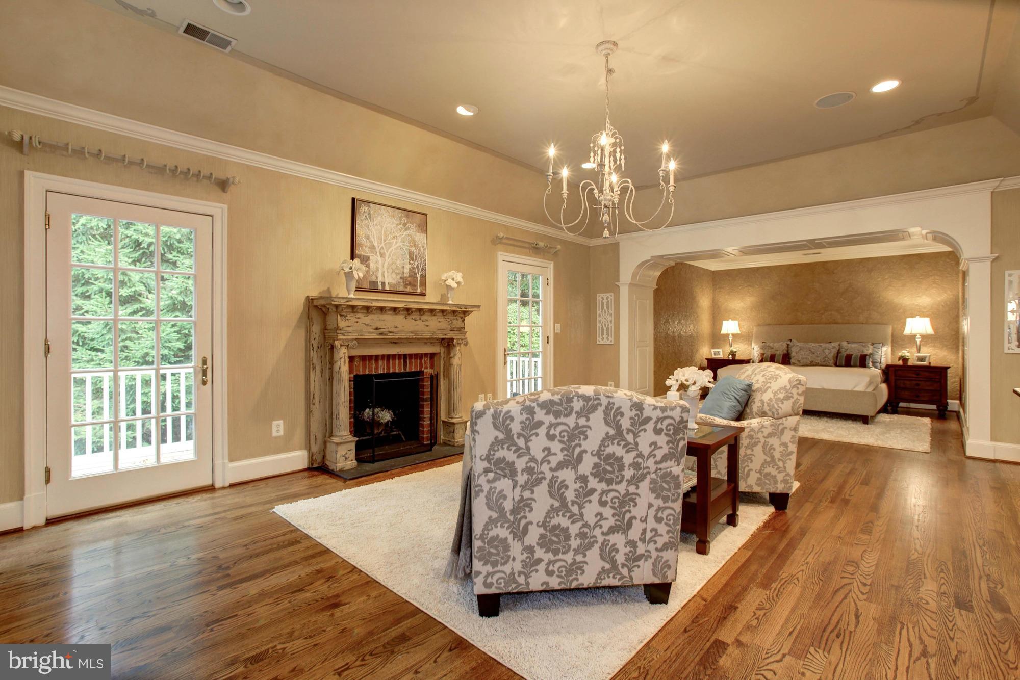 7414 Dulany Drive McLean, VA 22101 - Photo 16 of 30 a living room with furniture a fireplace and a chandelier