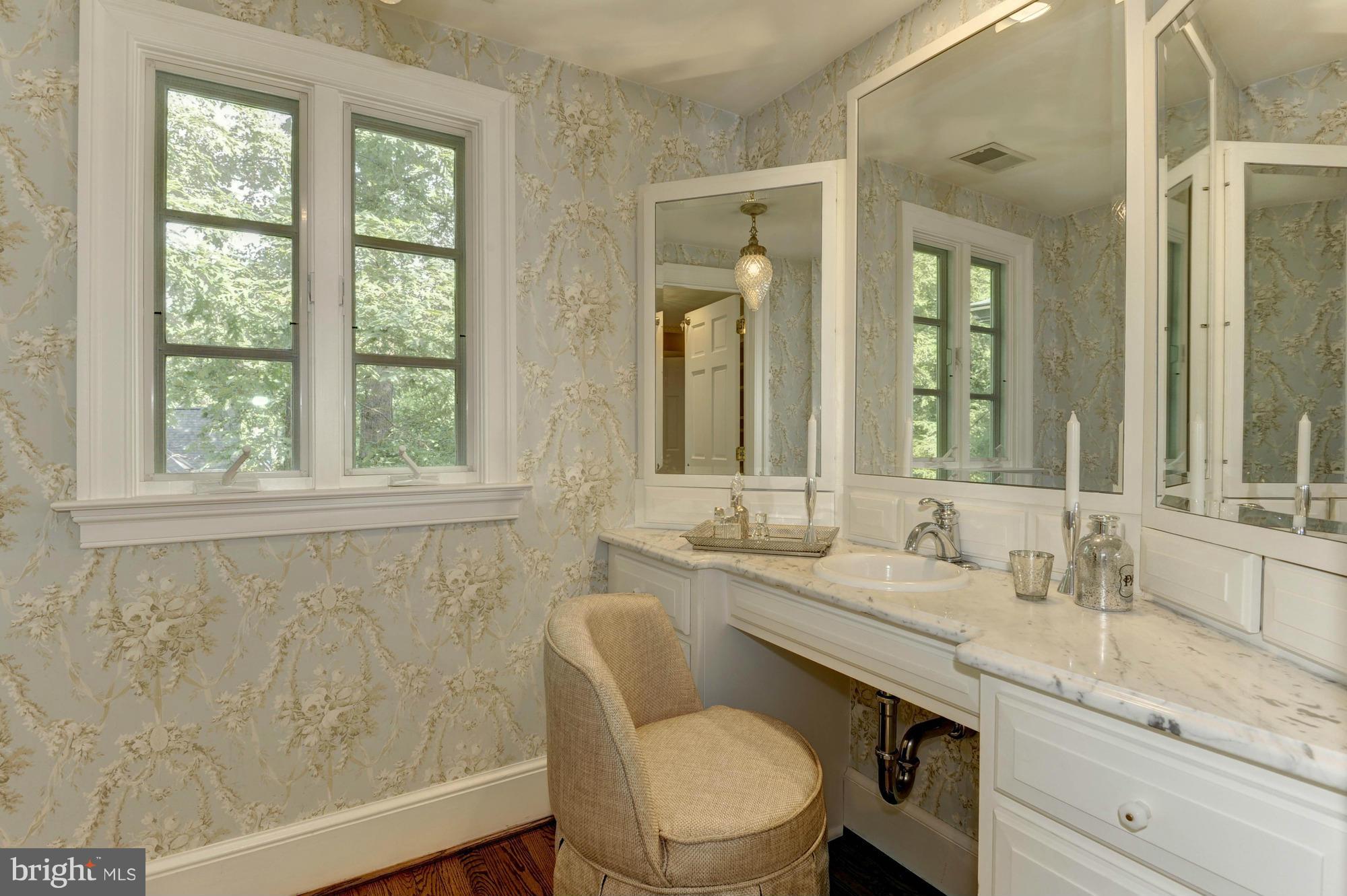 7414 Dulany Drive McLean, VA 22101 - Photo 19 of 30 a bathroom with a granite countertop sink mirror and a toilet