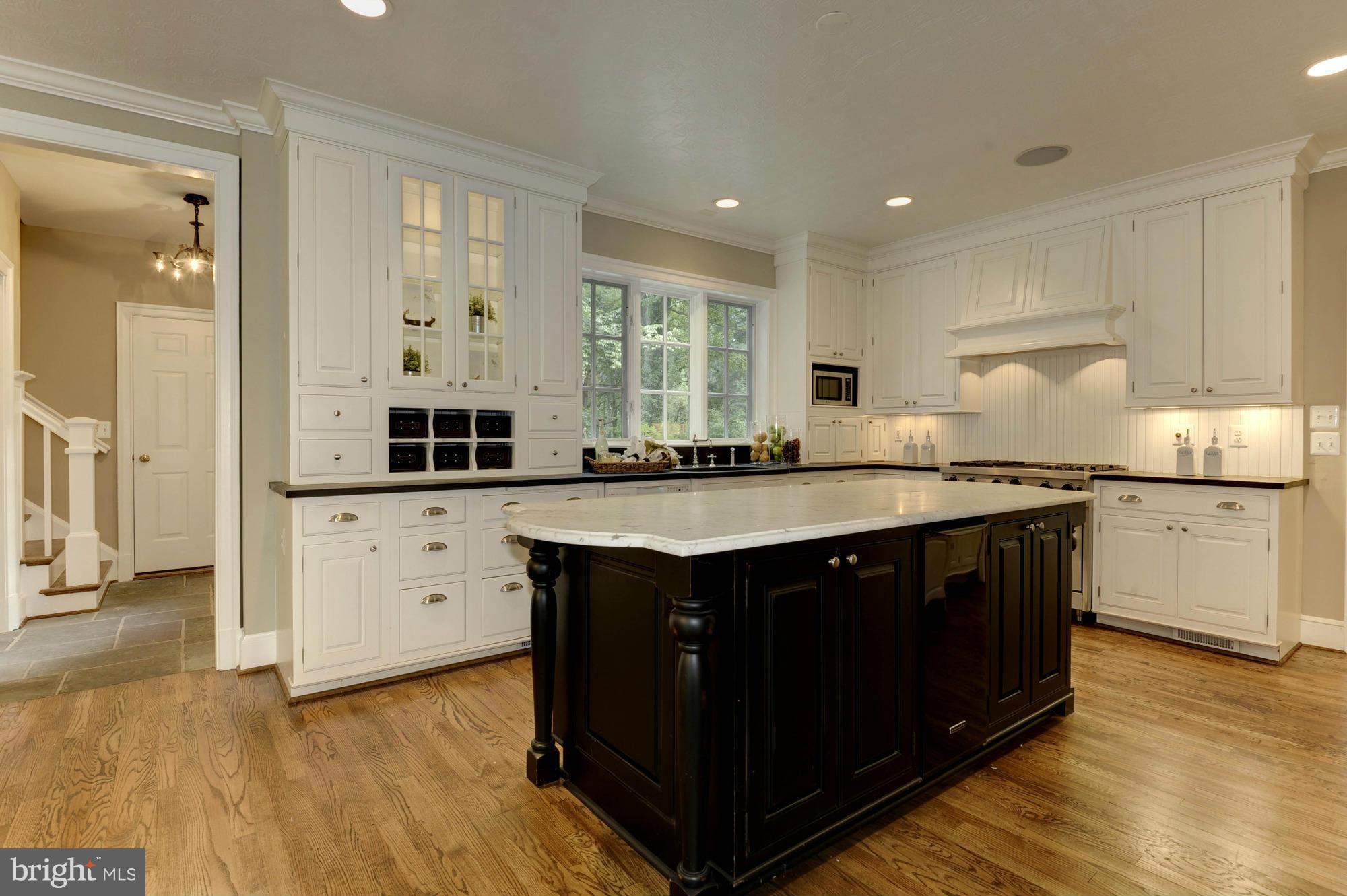 7414 Dulany Drive McLean, VA 22101 - Photo 9 of 30 a kitchen with stainless steel appliances granite countertop a sink stove and cabinets