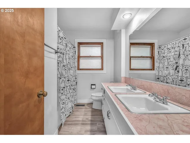 a bathroom with a sink a toilet a mirror and a tub