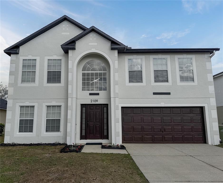 2109 Aitkin Loop Leesburg, FL 34748 - Photo 1 of 33 a front view of a house with garden