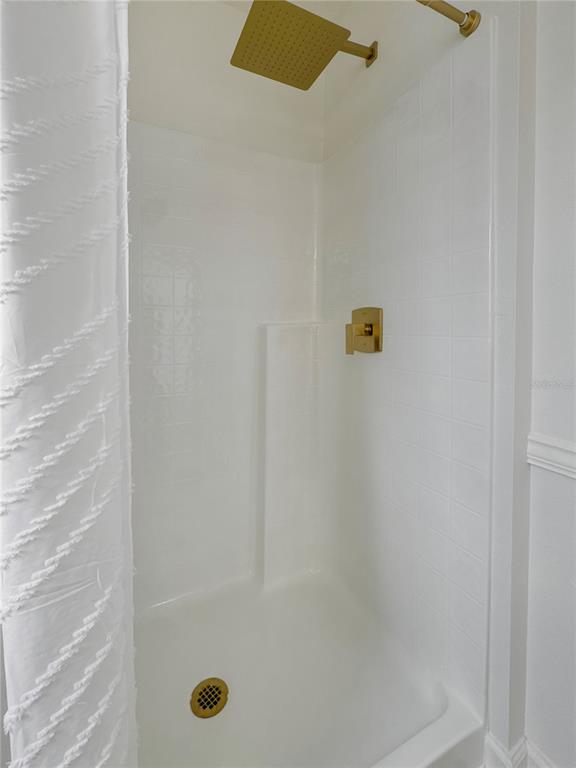 2109 Aitkin Loop Leesburg, FL 34748 - Photo 12 of 33 a bathroom with a shower