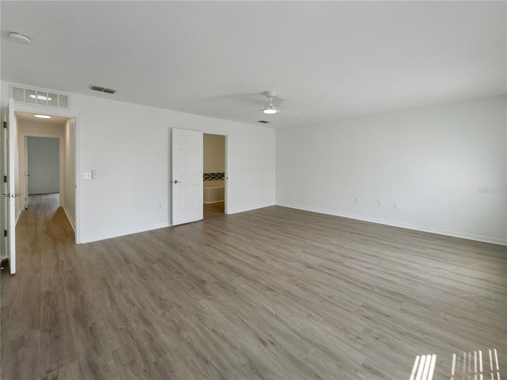 2109 Aitkin Loop Leesburg, FL 34748 - Photo 16 of 33 wooden floor in an empty room
