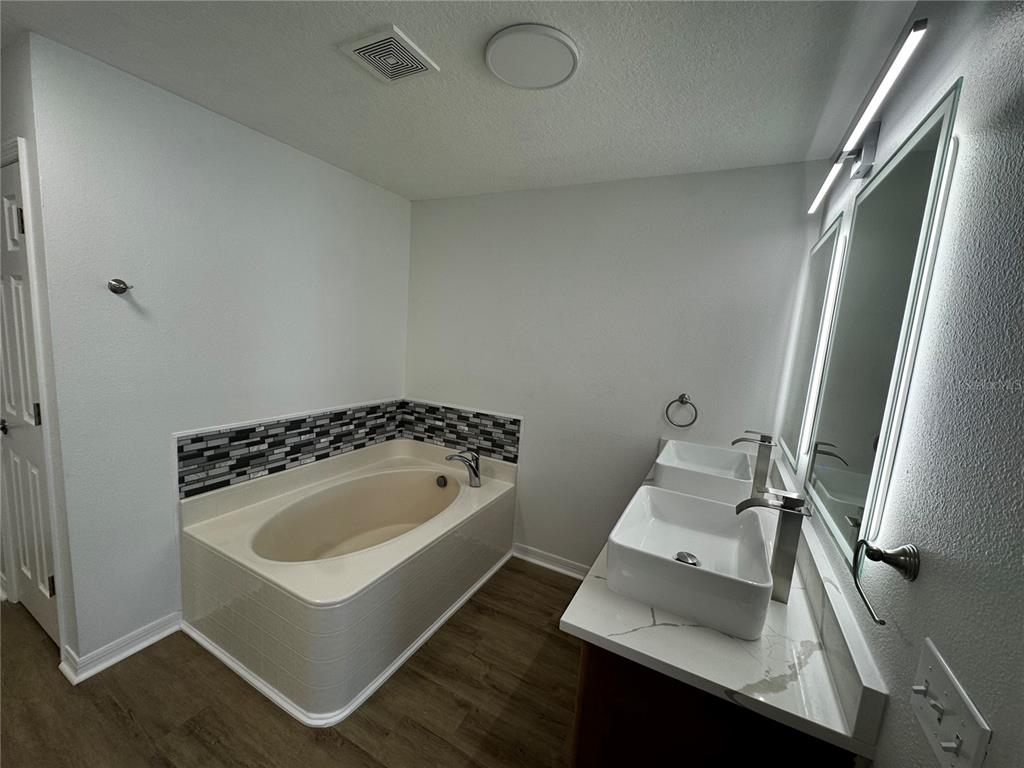 2109 Aitkin Loop Leesburg, FL 34748 - Photo 18 of 33 a bathroom with a sink toilet and mirror