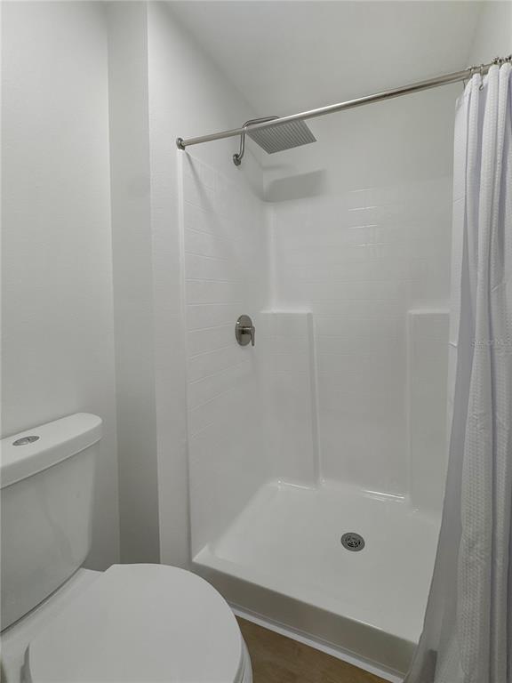 2109 Aitkin Loop Leesburg, FL 34748 - Photo 19 of 33 a bathroom with a shower and a toilet
