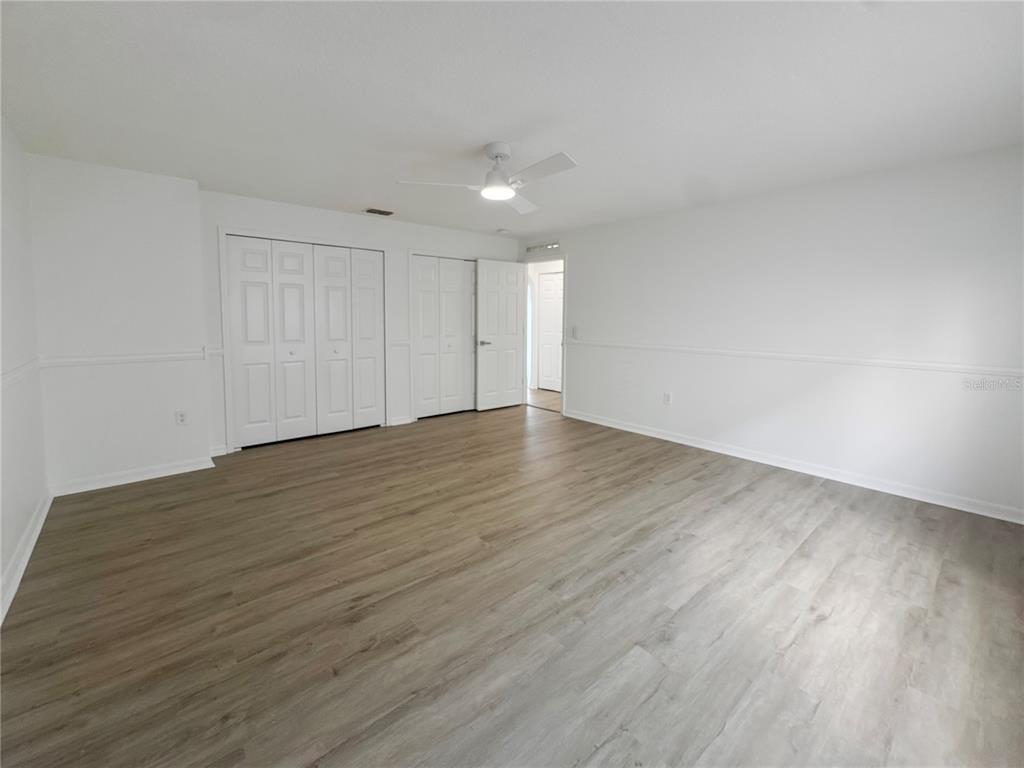 2109 Aitkin Loop Leesburg, FL 34748 - Photo 25 of 33 a view of an empty room with wooden floor