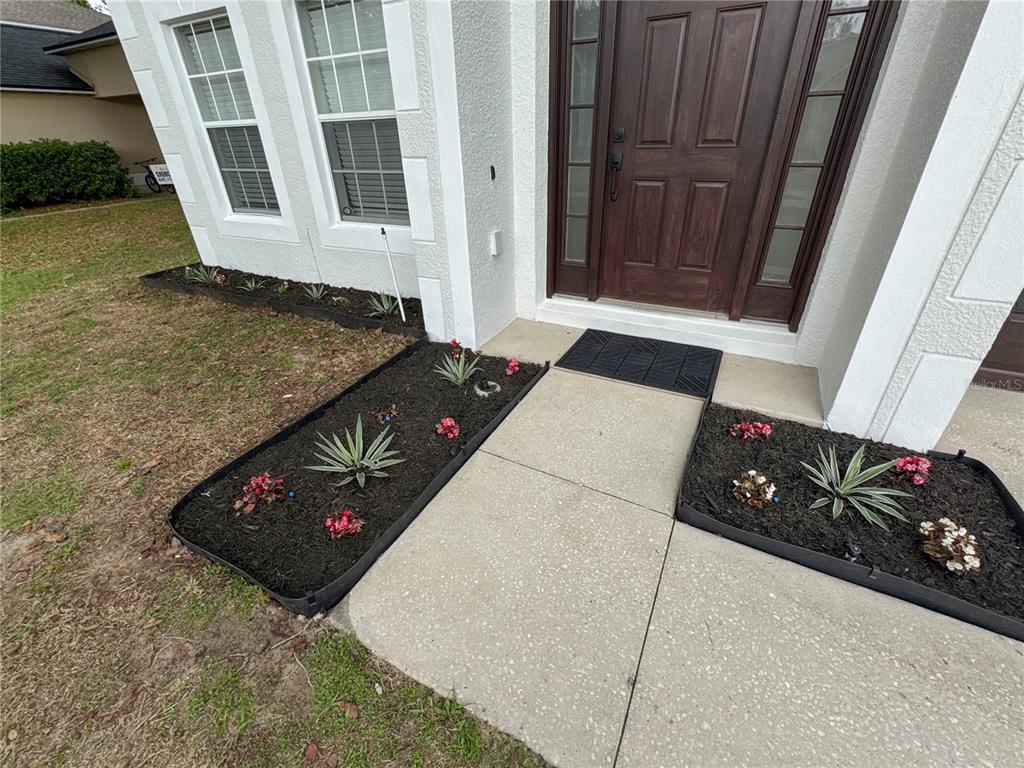 2109 Aitkin Loop Leesburg, FL 34748 - Photo 32 of 33 a view of a door and chair in wooden floor