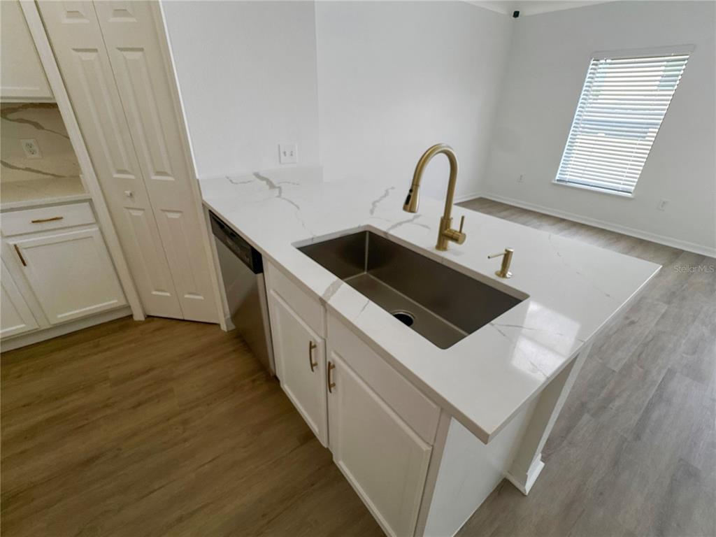 2109 Aitkin Loop Leesburg, FL 34748 - Photo 4 of 33 a kitchen with a sink and a stove top oven