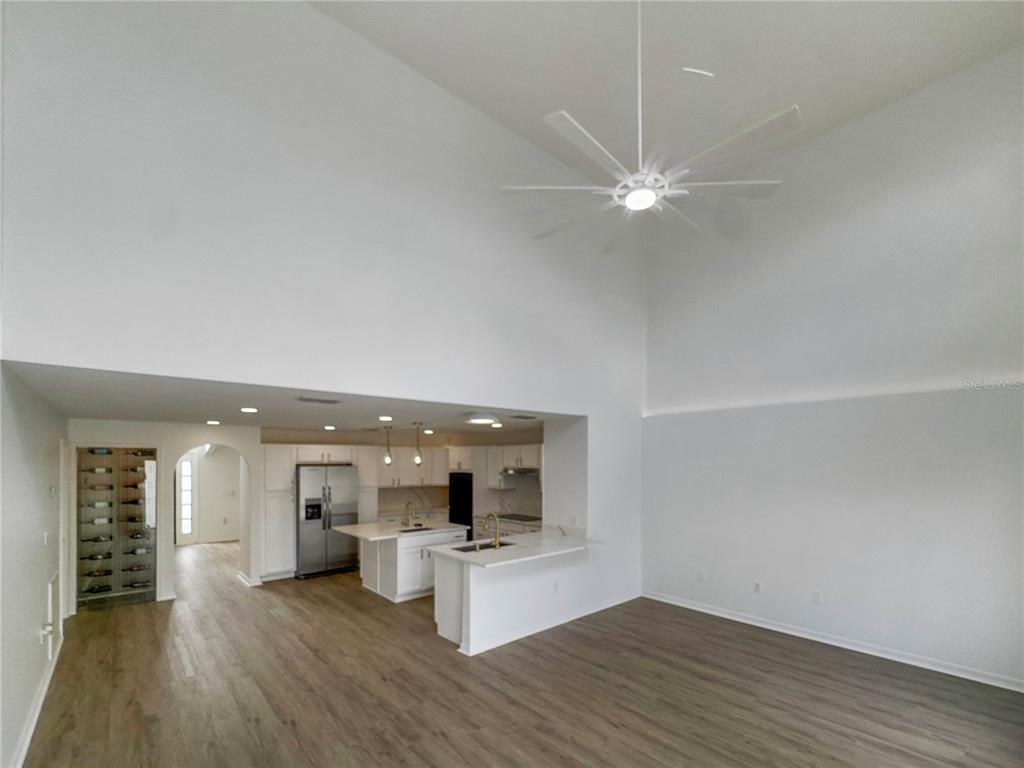 2109 Aitkin Loop Leesburg, FL 34748 - Photo 7 of 33 wooden floor in an empty room with a window