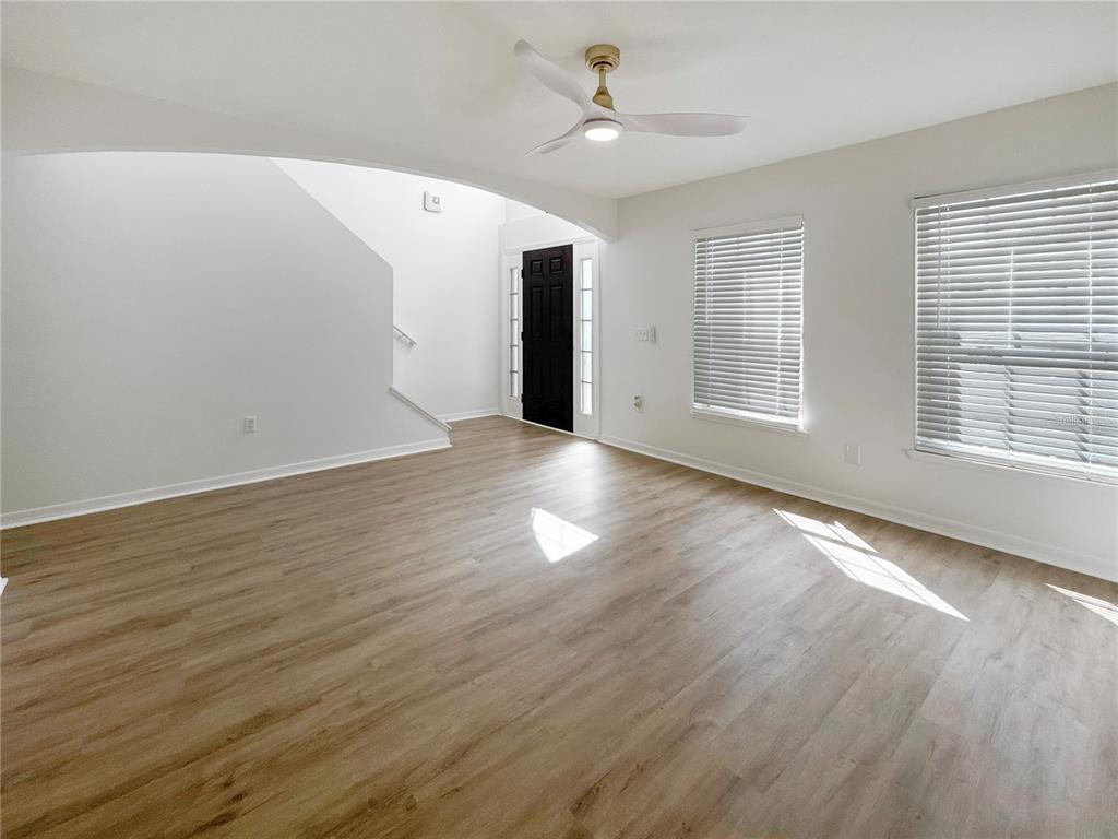 2109 Aitkin Loop Leesburg, FL 34748 - Photo 10 of 33 a view of an empty room with wooden floor and a window