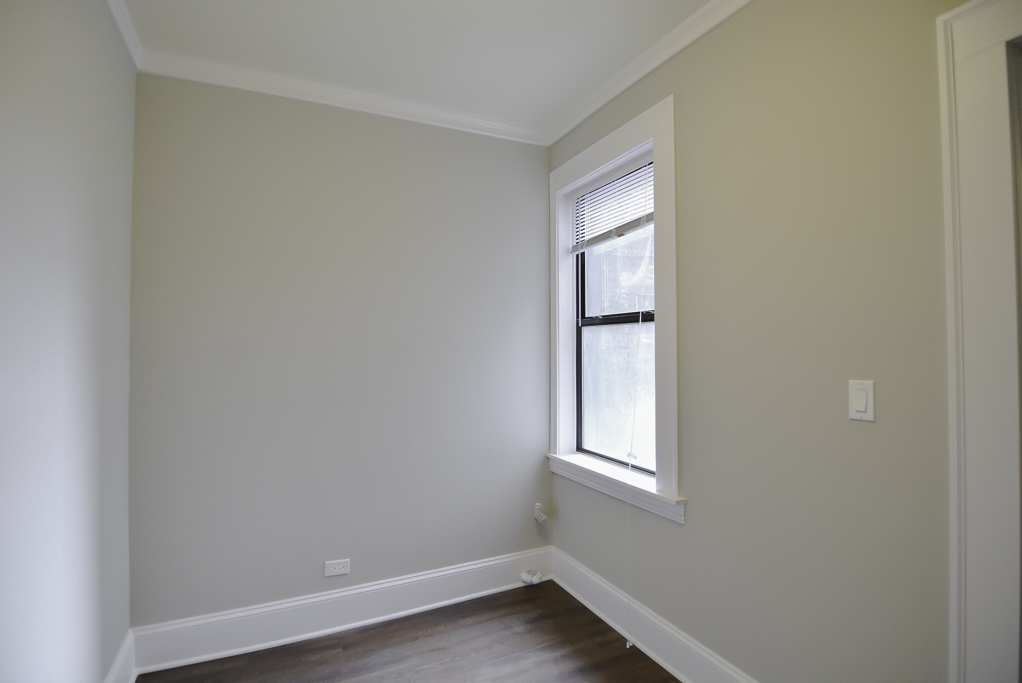 817 West Lakeside Place, Unit 705 Chicago, IL 60640 - Photo 12 of 19 an empty room with wooden floor and windows