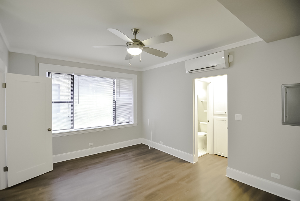817 West Lakeside Place, Unit 705 Chicago, IL 60640 - Photo 10 of 19 a view of an empty room with wooden floor and a window