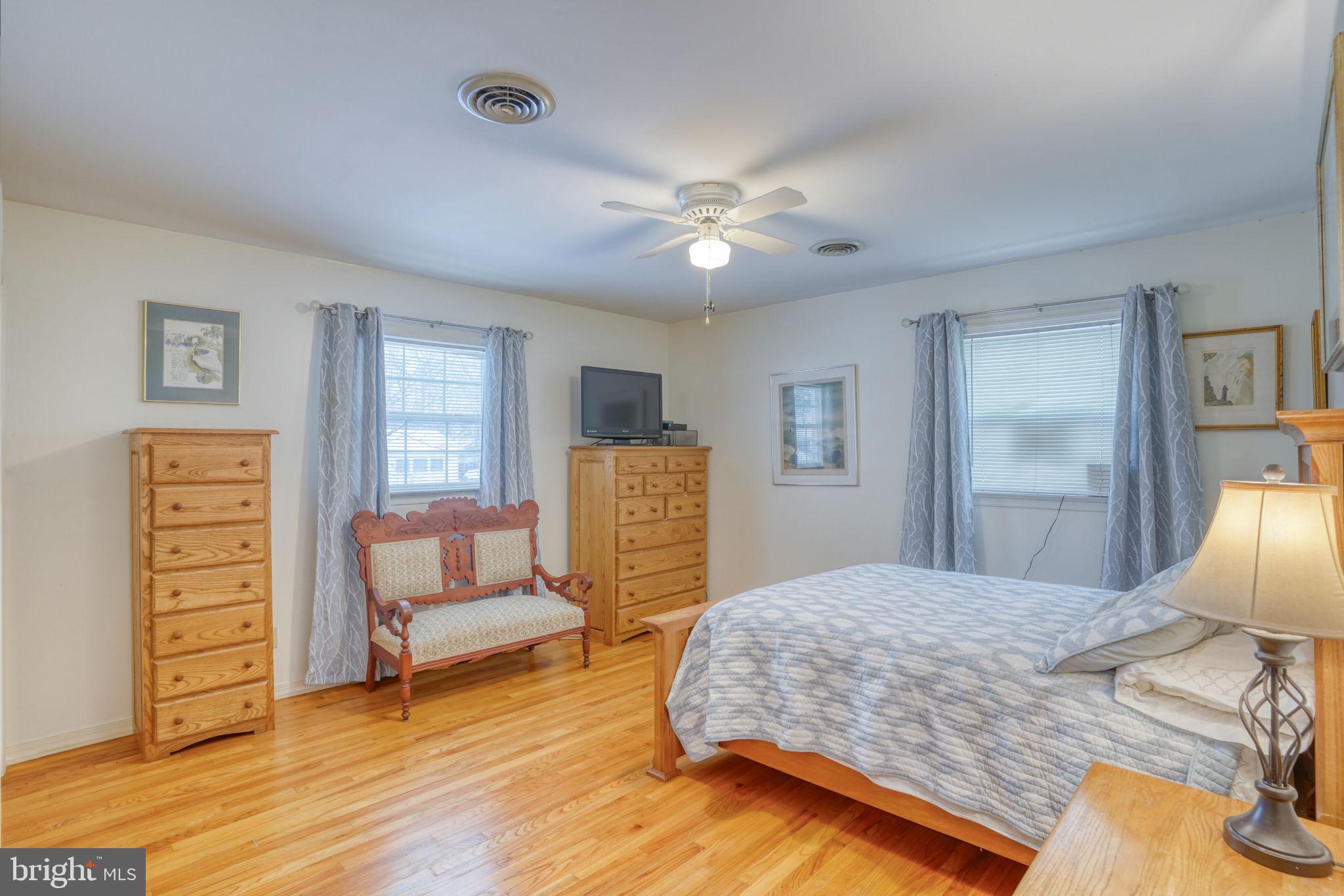 131 Rodric Terrace Dover, DE 19901 - Photo 21 of 45 a bedroom with a bed and wooden floor
