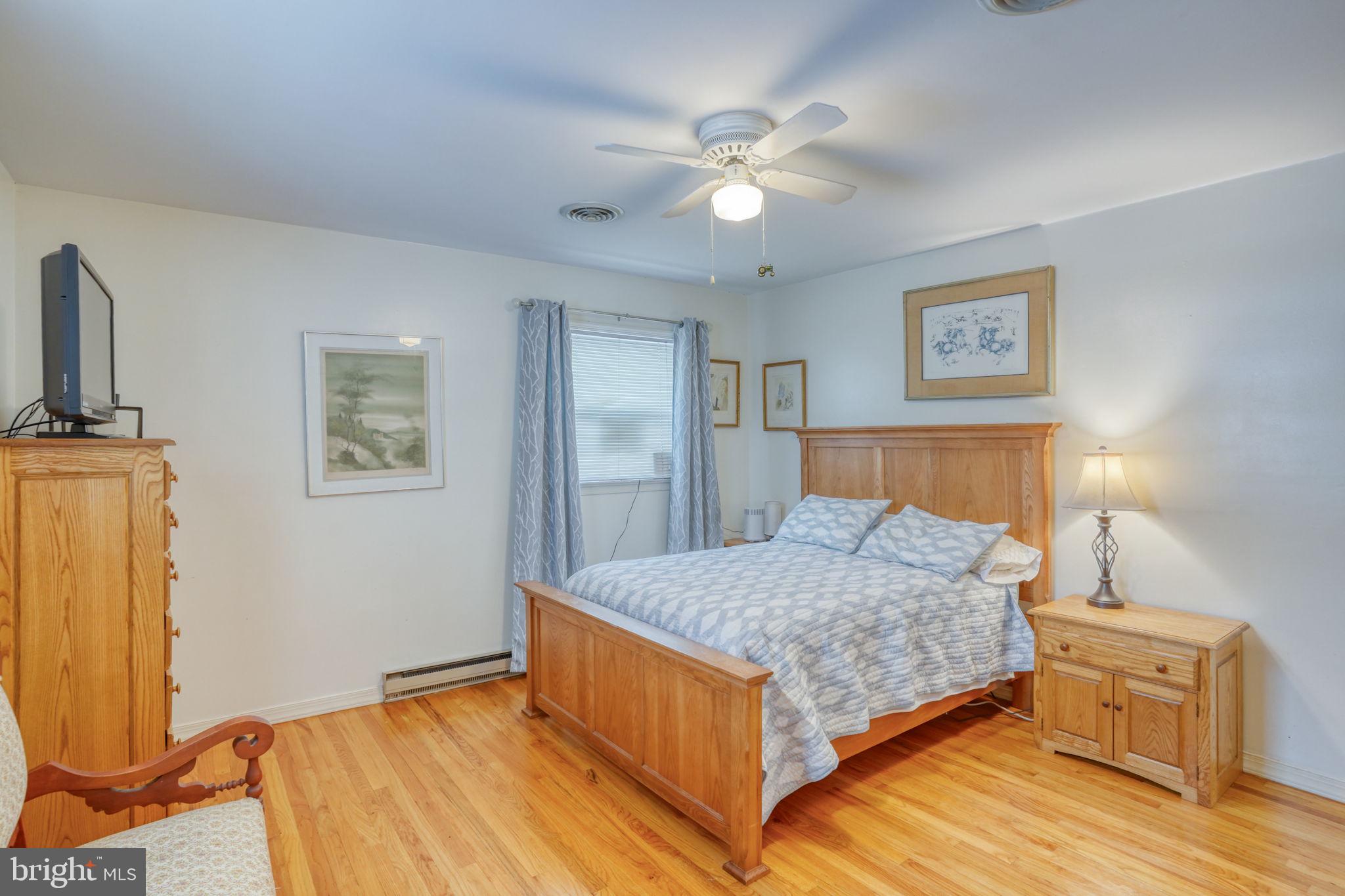 131 Rodric Terrace Dover, DE 19901 - Photo 22 of 45 a bedroom with a bed and a chandelier