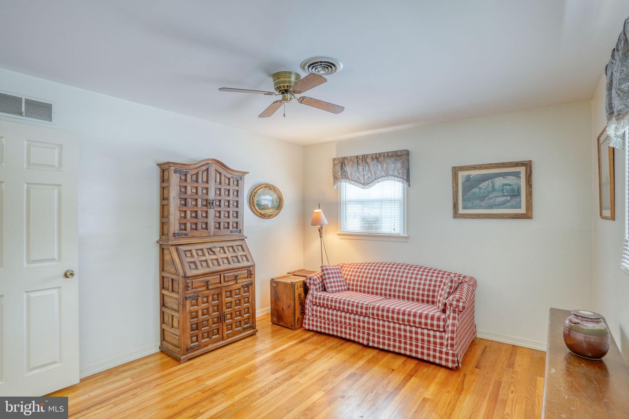 131 Rodric Terrace Dover, DE 19901 - Photo 23 of 45 a bedroom with a bed and wooden floor