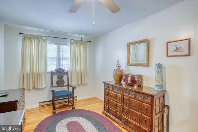 a living room with furniture and two windows