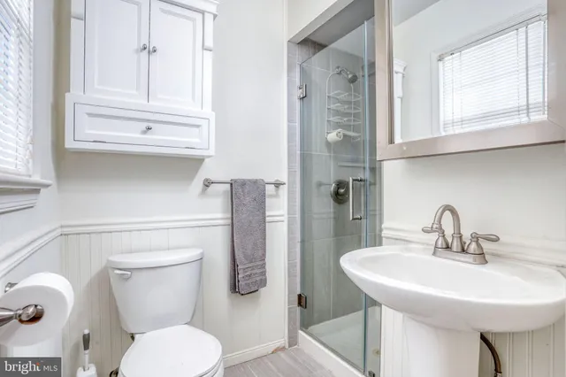 a bathroom with a toilet sink and a mirror