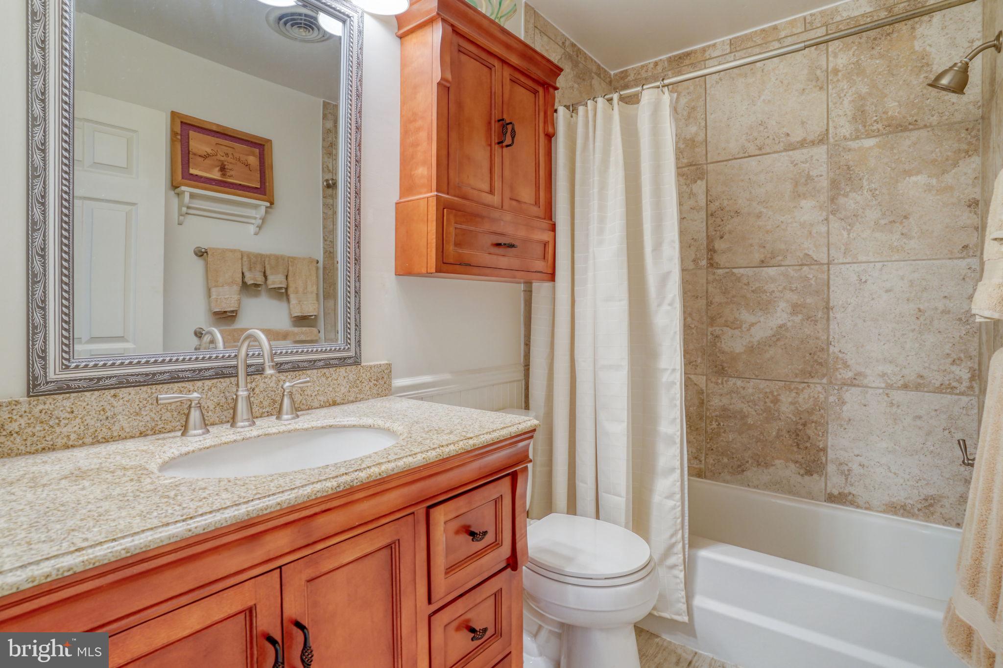 131 Rodric Terrace Dover, DE 19901 - Photo 28 of 45 a bathroom with a granite countertop sink a toilet and shower
