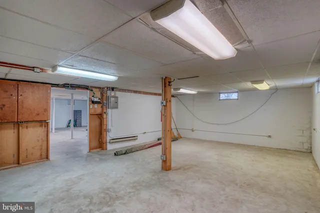 an aerial view of a house with swimming pool and a yard