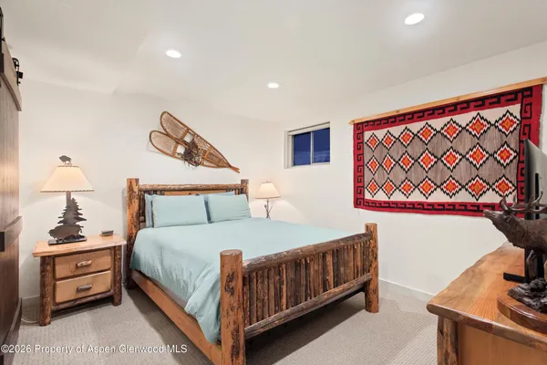 a bedroom with a bed and a night stand