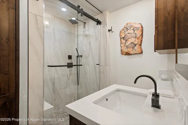 a bathroom with a sink and mirror