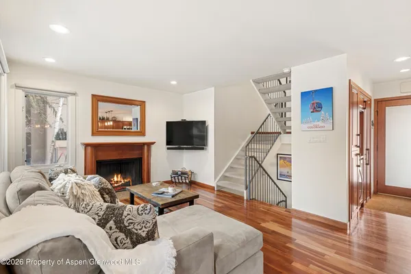 a living room with furniture a flat screen tv and a fireplace