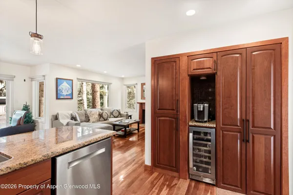 a kitchen with stainless steel appliances granite countertop a refrigerator and a sink