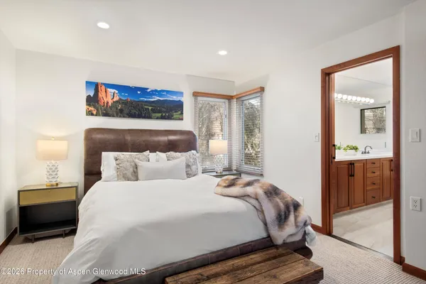 a bedroom with a bed and a mirror