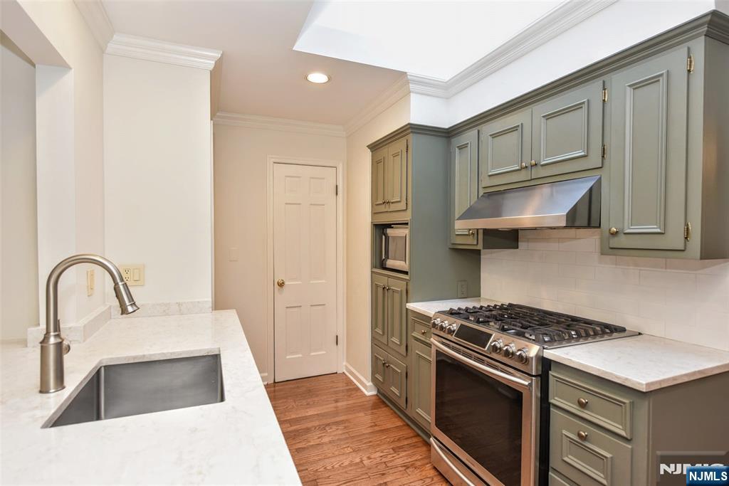 60 Dimmig Road Upper Saddle River, NJ 07458 - Photo 18 of 40 a kitchen with stainless steel appliances granite countertop a sink stove and refrigerator